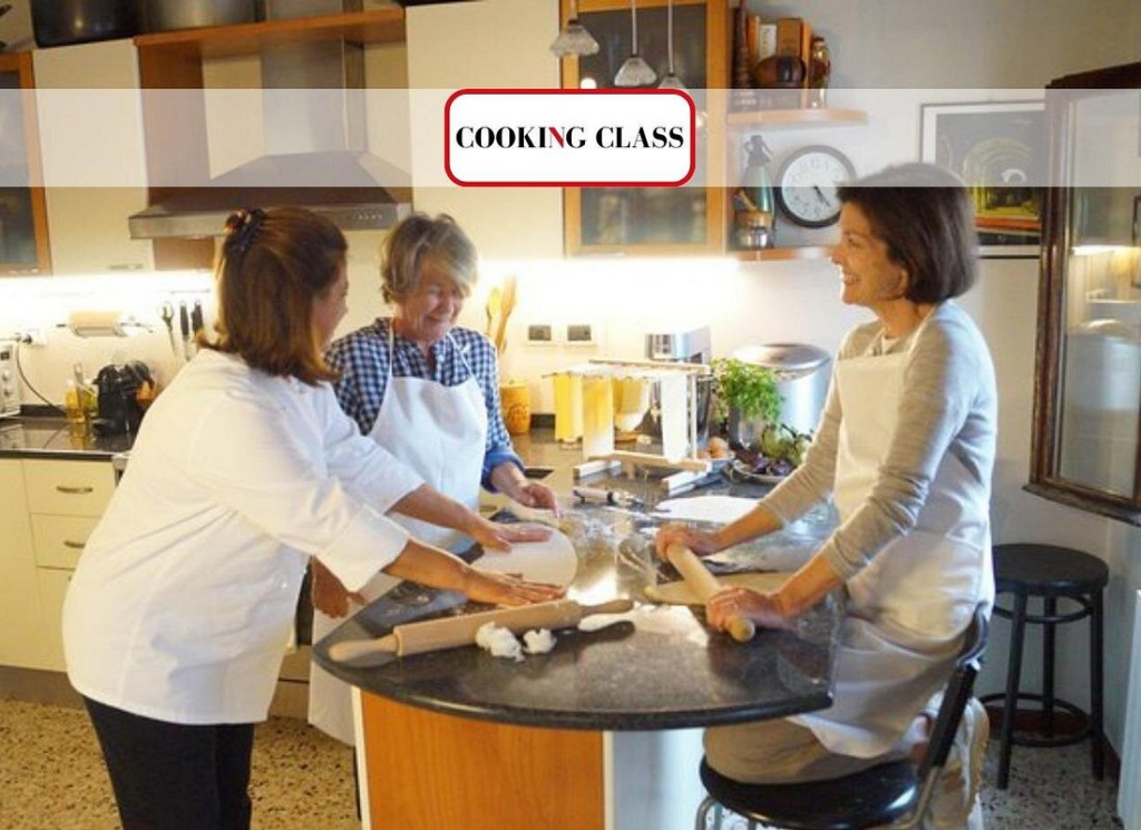 Small group preparing fresh pasta together in a friendly home-style kitchen during a hands-on culinary workshop, enjoyable and authentic experience typical of the best venice cooking classes
