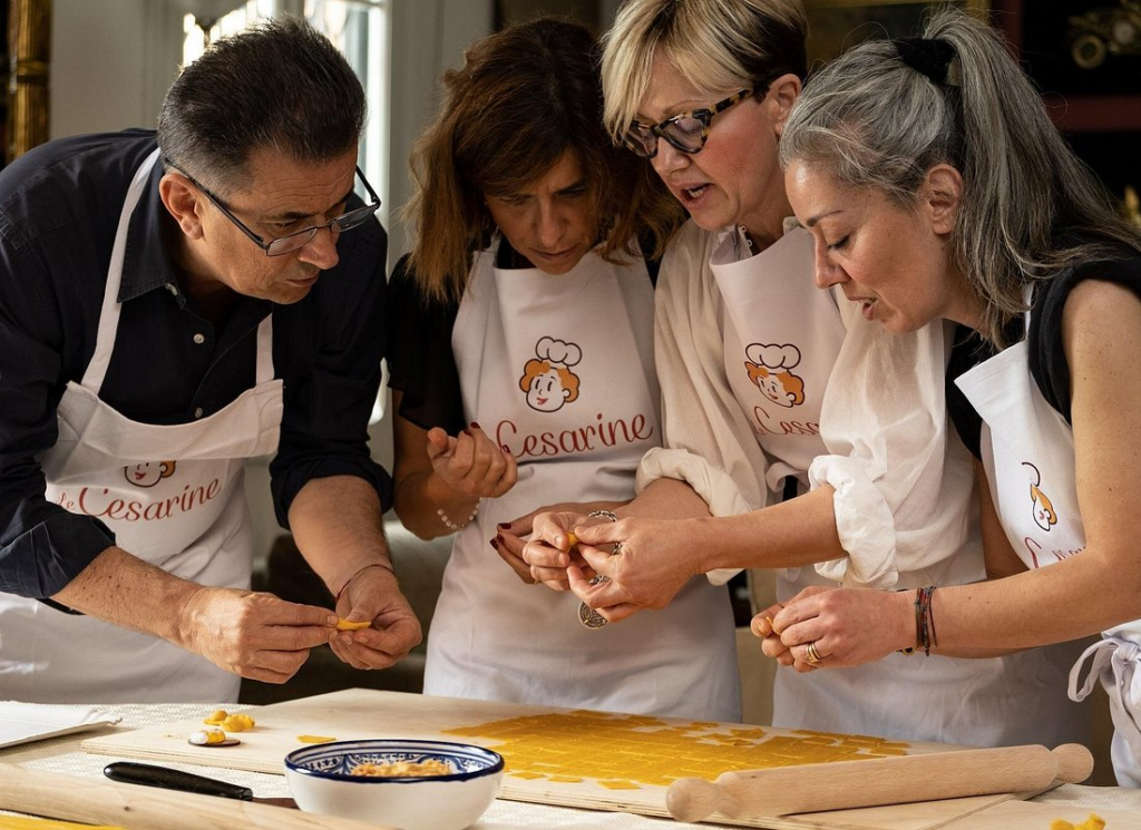 Small group shaping handmade pasta together under guidance from a local instructor, immersive hands-on culinary experience commonly featured in the best venice cooking classes.