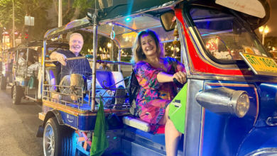 Travelers riding through Bangkok at night during a lively tuk tuk food tour Bangkok street adventure