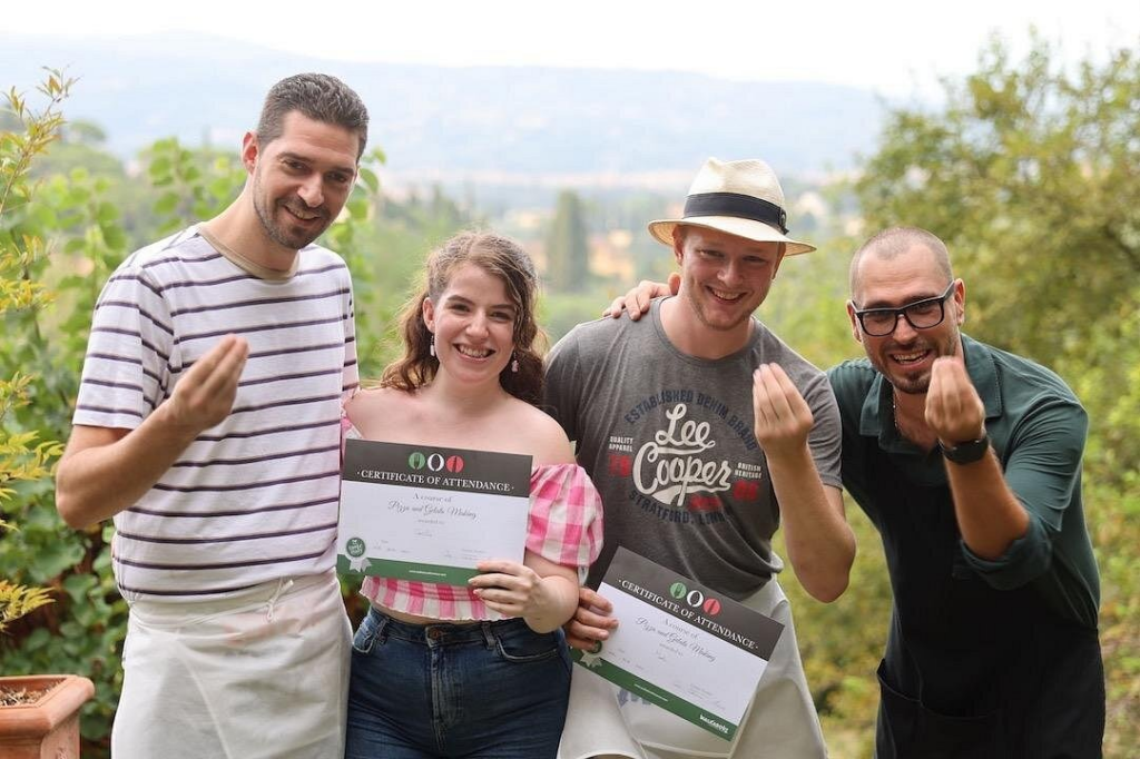 Participants celebrating with certificates after a Florence food and wine tour experience in the Tuscan countryside