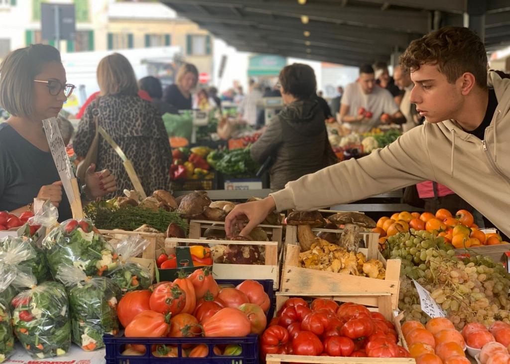 Local market scene with fresh produce and mushrooms during a Florence food and wine tour in Italy
