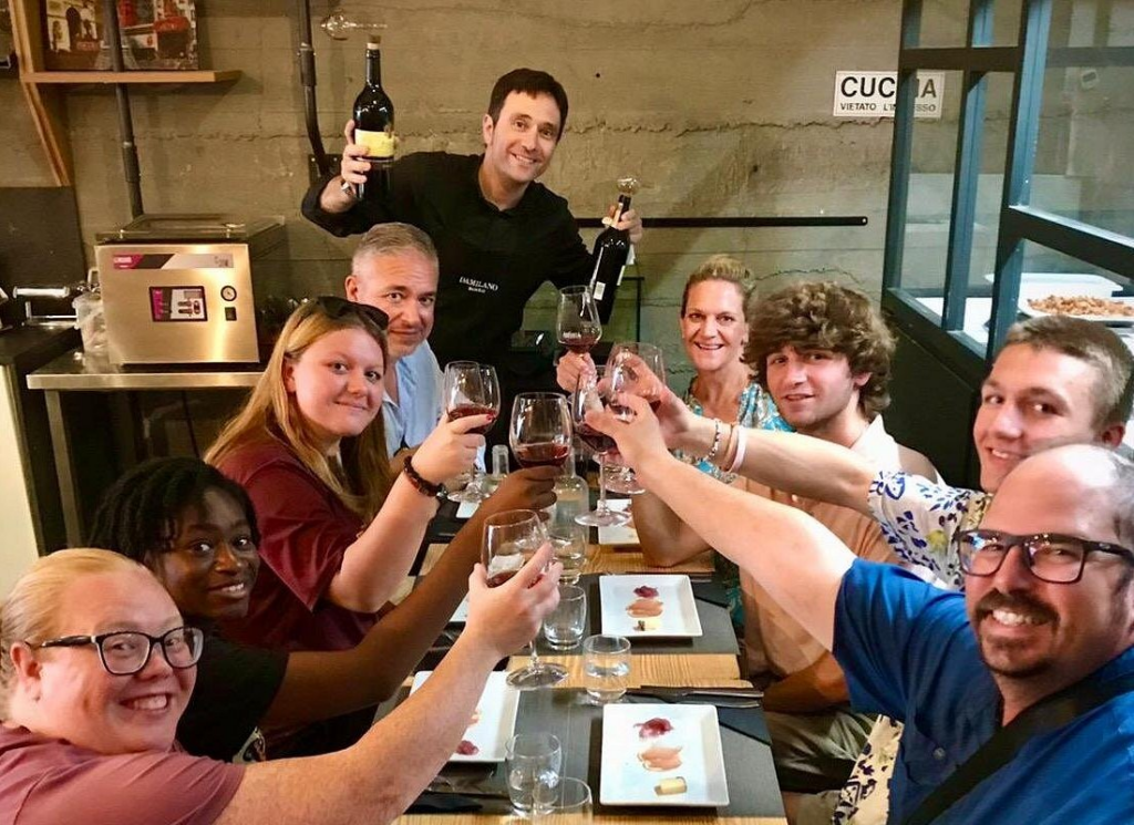 Wine tasting Rome group raising glasses during a guided tasting experience with a sommelier in a restaurant