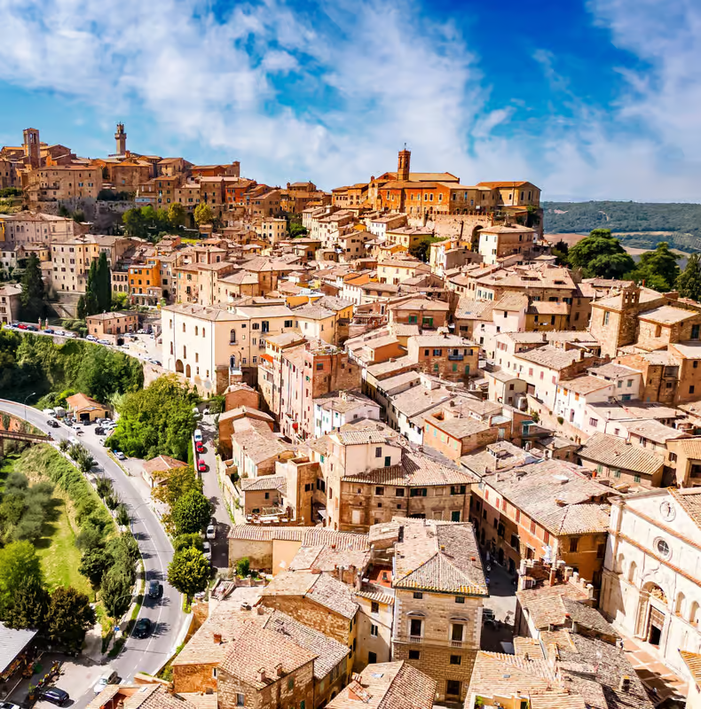 Scenic hilltop town in Tuscany with terracotta rooftops and countryside views on wine tours from Rome