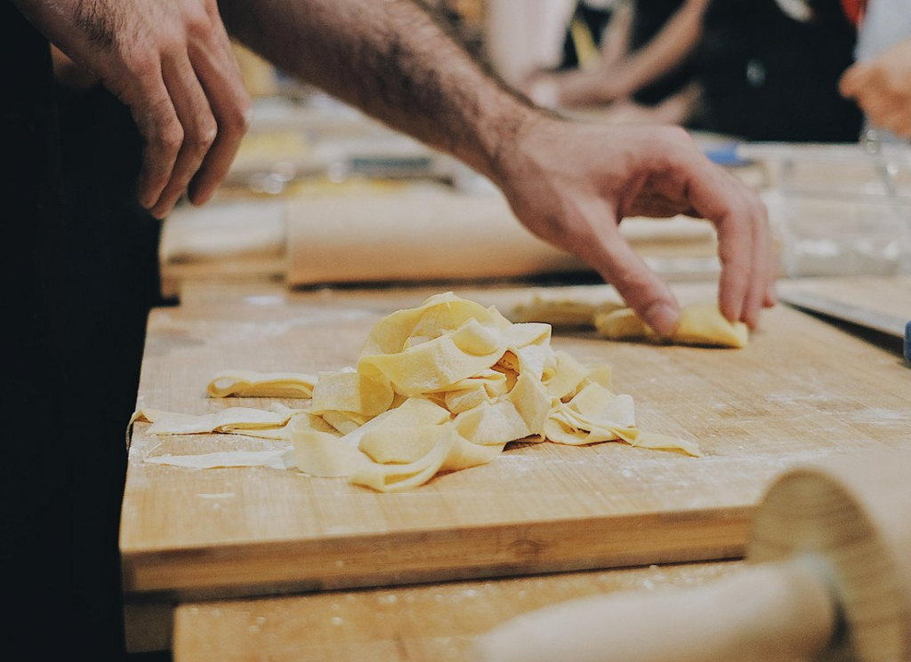Fresh pasta being prepared by hand during a cooking experience included in wine tours from Rome