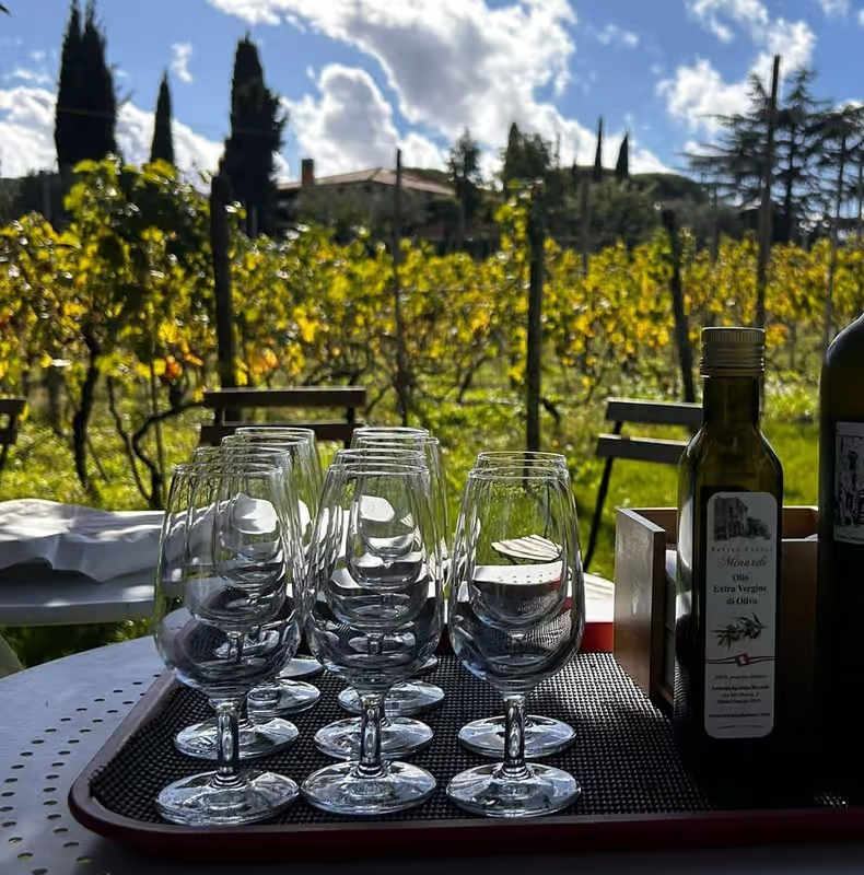 Wine glasses set up for tasting overlooking vineyards in the Italian countryside on wine tours from Rome