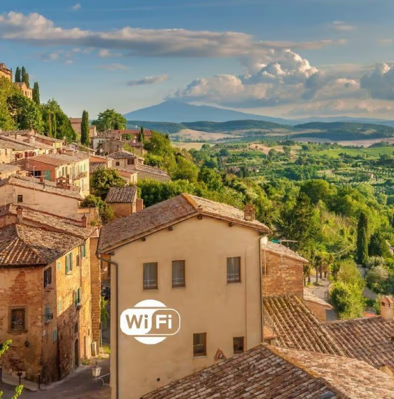 Charming hilltop village in Tuscany with terracotta rooftops and rolling countryside views, a picturesque stop on tuscany wine tours from rome showcasing classic Italian landscapes.
