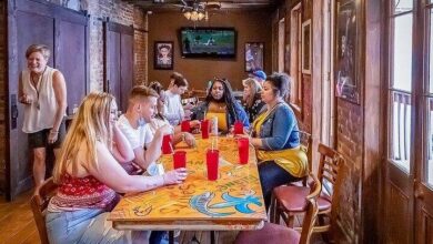 Group of diners enjoying a meal and conversation inside a rustic French Quarter restaurant on one of the best food tours in New Orleans.