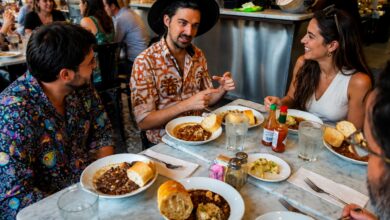 A guide shares stories over bowls of gumbo as guests enjoy local dishes during a French Quarter food tour at a lively New Orleans restaurant.