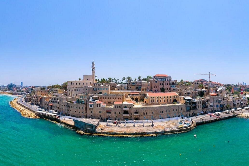 Carmel Market Tel Aviv near the historic Jaffa waterfront, showcasing the vibrant coastline, ancient stone architecture, and one of the city's most iconic food and cultural districts.