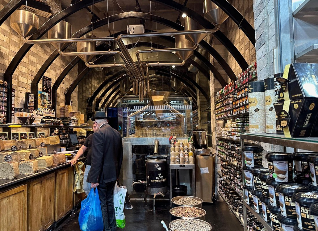 Jerusalem Food Tours visit specialty shops filled with freshly roasted tahini, halva, spices, and local delicacies at the bustling Mahane Yehuda Market in Jerusalem.