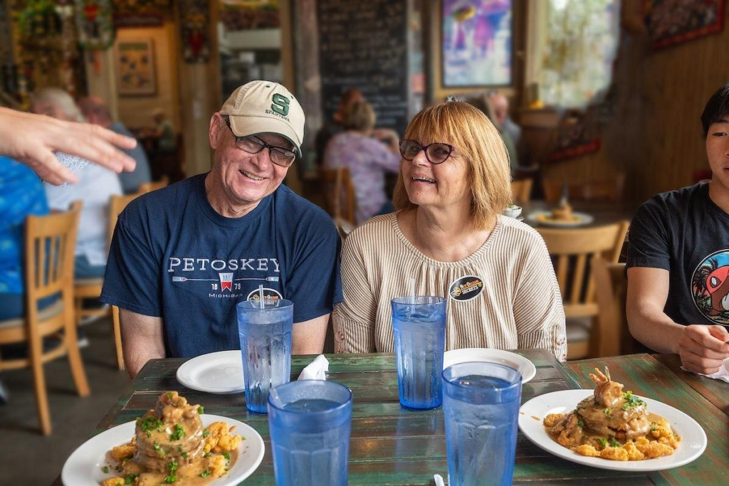 New Orleans food walking tour with guests enjoying classic Creole dishes inside a cozy local restaurant during a guided culinary experience.