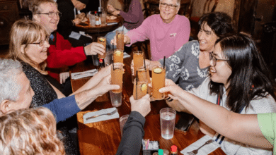Friends raising classic cocktails in a lively French Quarter bar during a New Orleans cocktail tour.
