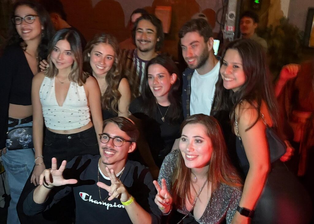 tel aviv party scene with a group of friends enjoying the lively atmosphere inside a popular Tel Aviv nightclub during a night out.